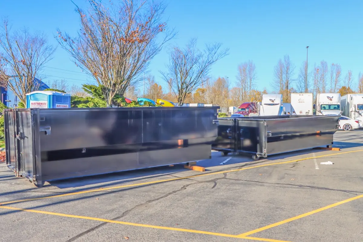 Professional dumpster rental service with roll-off container on residential driveway in West Richland